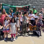 Garden Players Memorial Day Parade after photo with sign